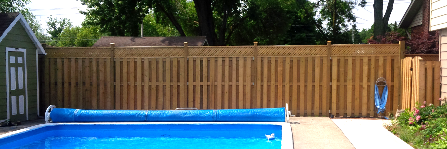 Fenced in backyard with pool